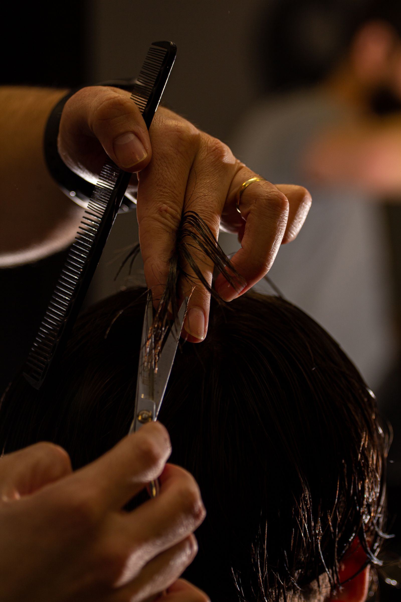 Barber cutting hair with scissors and comb; concept style imagery