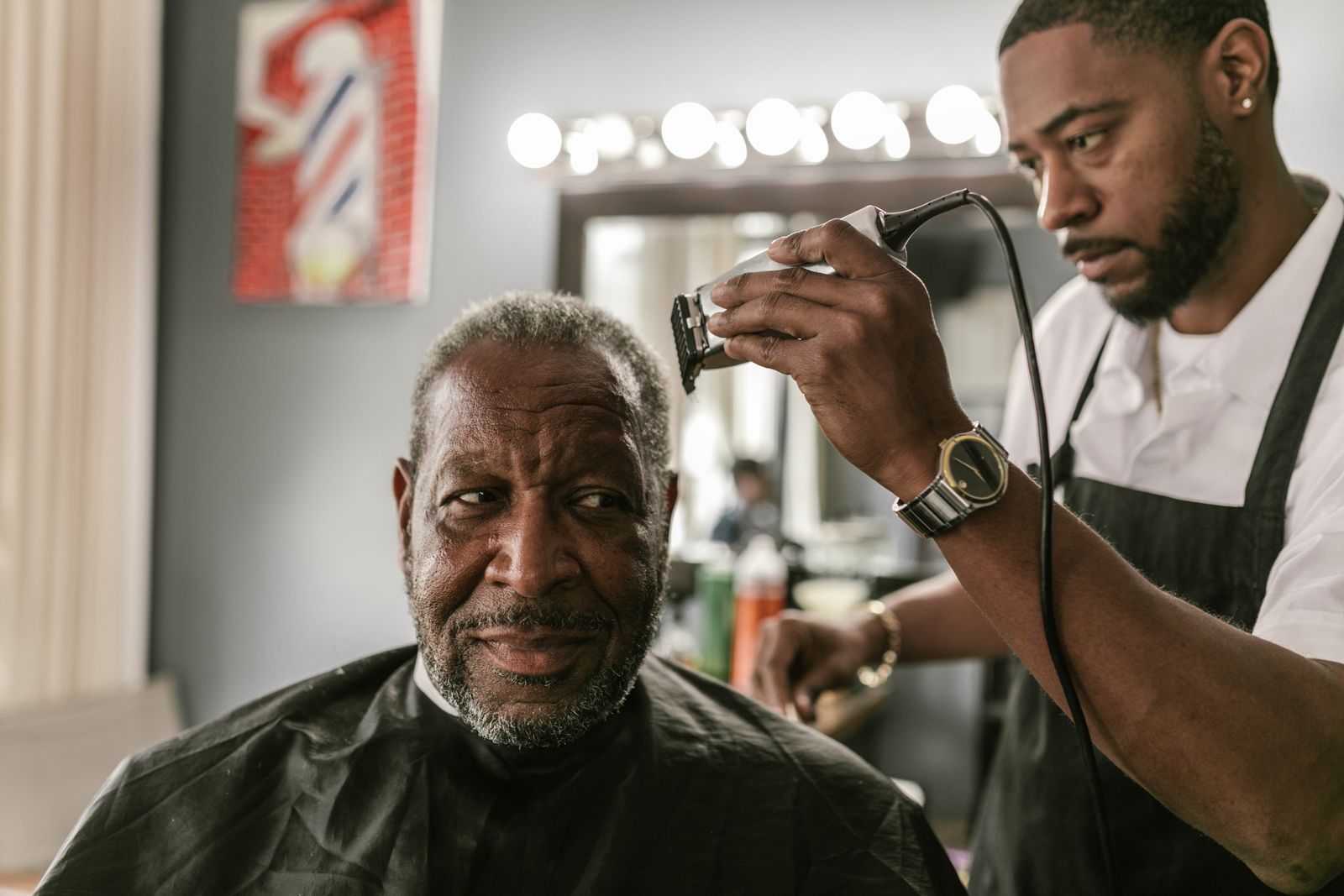 Barber shaping a client’s cut with clippers; concept style imagery