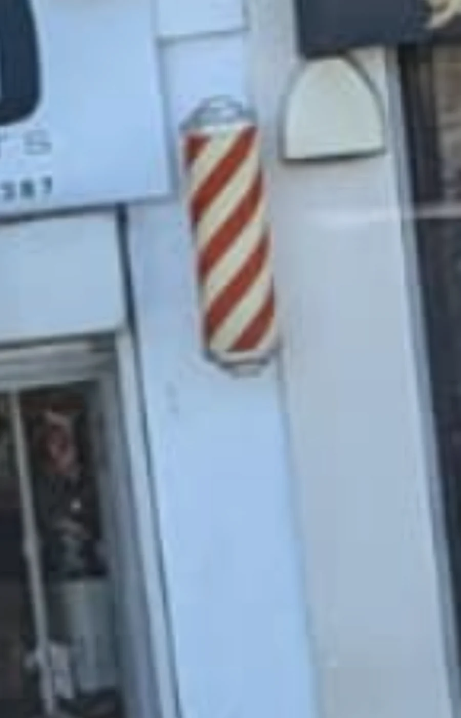 Traditional barber pole outside Urban Trend Barbers